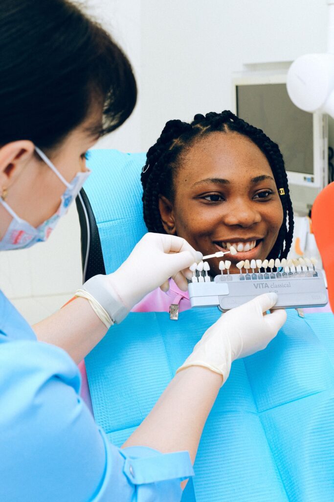 dental patient with tooth shade guide veneers