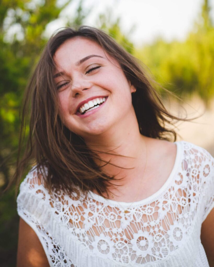 woman smiling with hair blowing