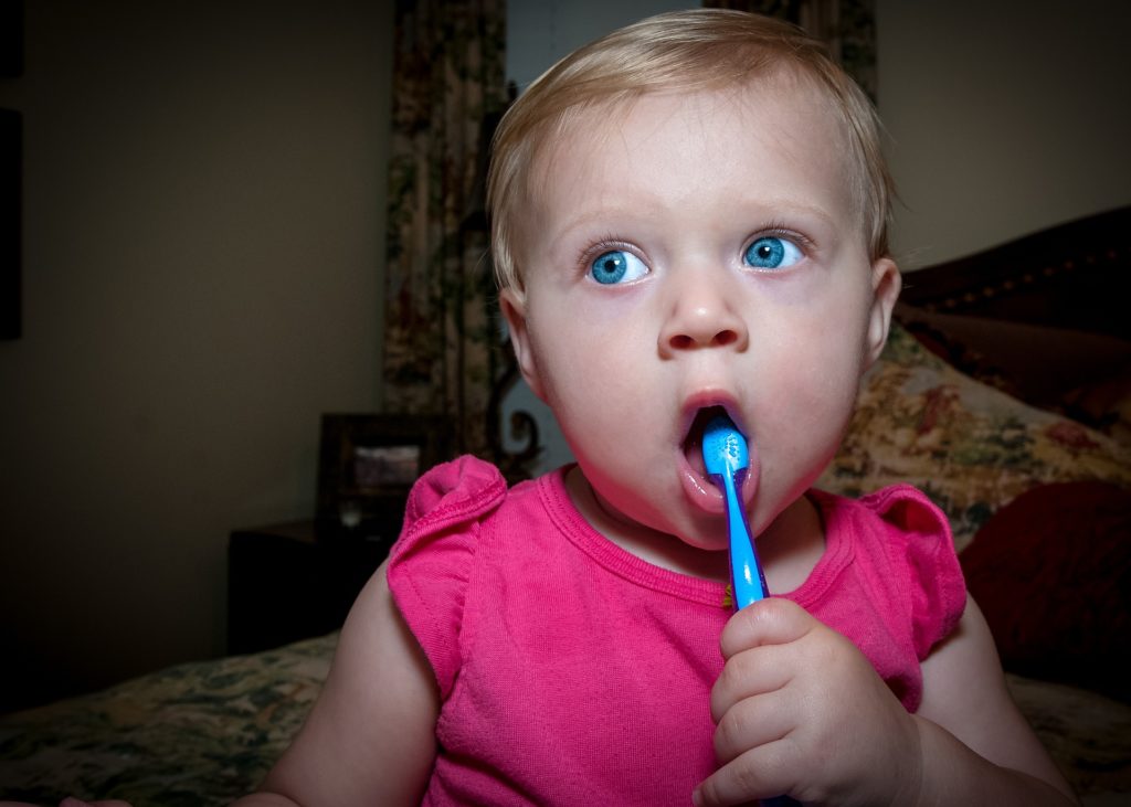  baby girl brushing her teeth