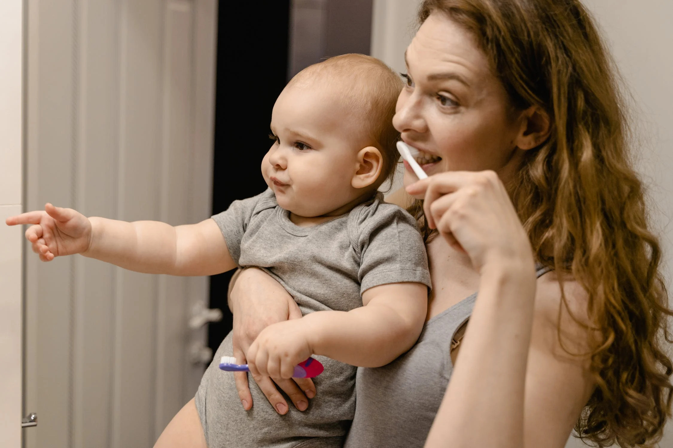 Woman Brushing Holding Child