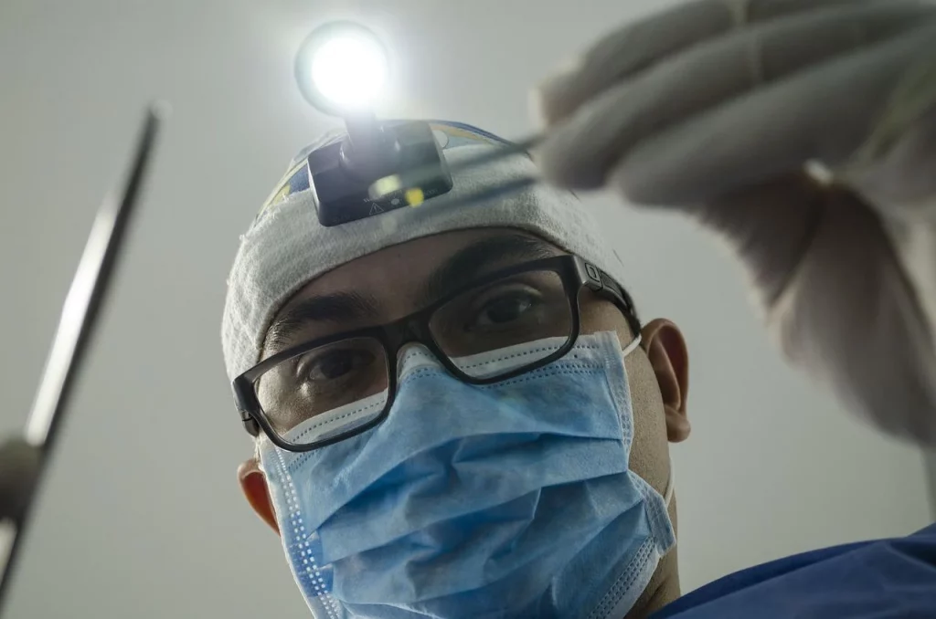 A dentist preparing to insert a crown