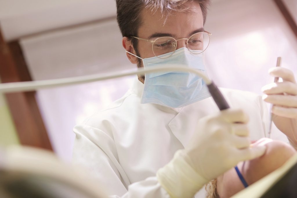 A dentist performing dental bonding on a patient