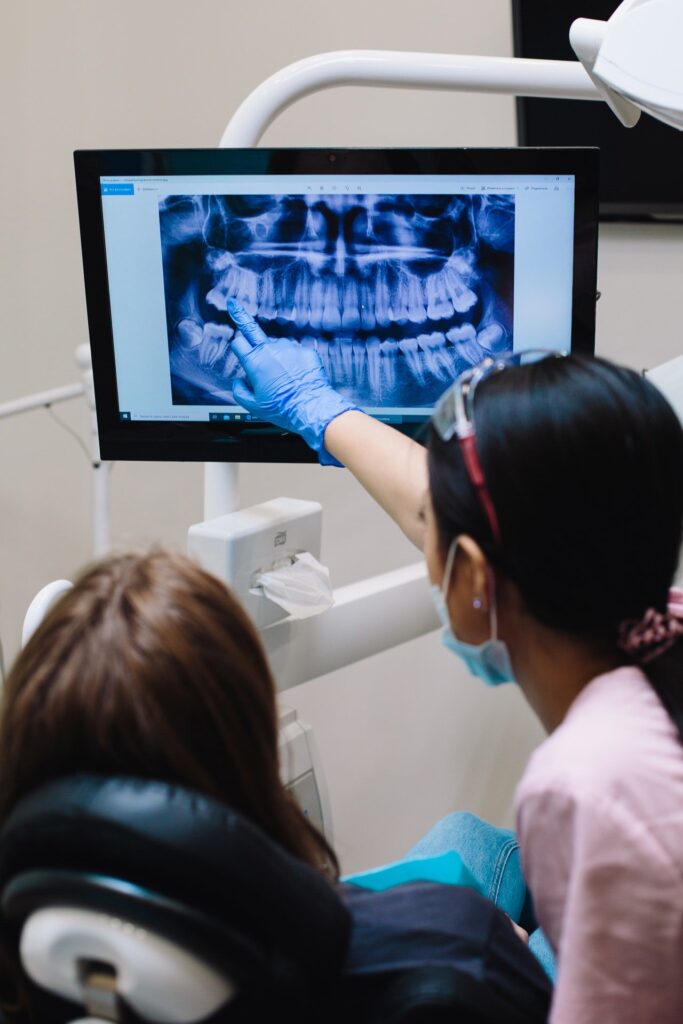 A dentist reviewing an x-ray.