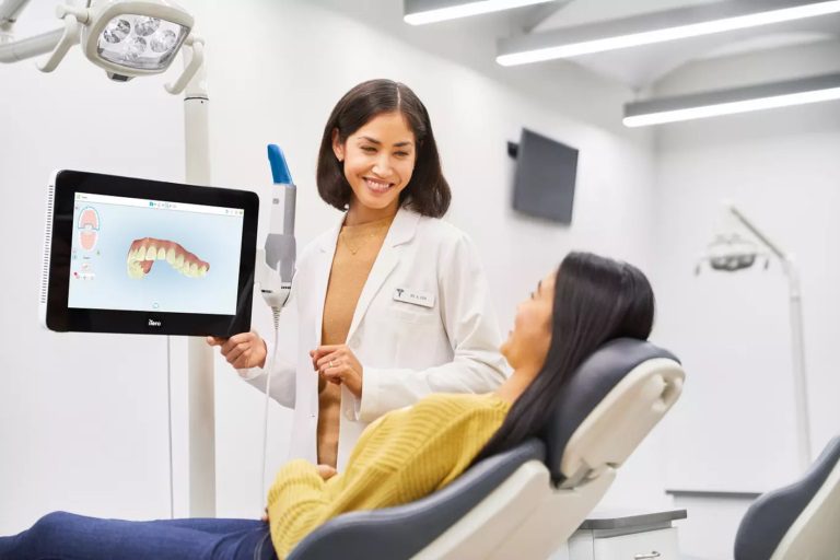 Dentist showing a patient an image of their teeth.