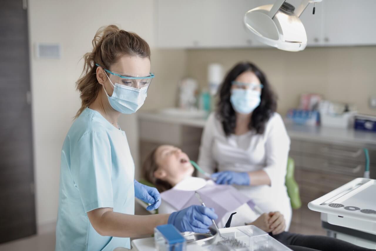 Female dentist with mother and child.