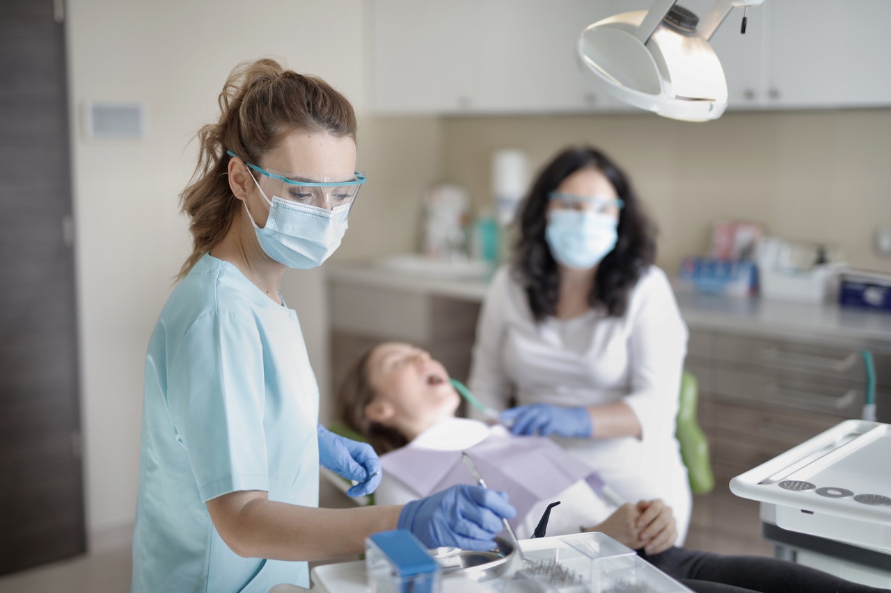 Female dentist with mother and child.
