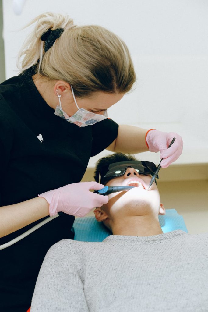 A dentist prepares a patient’s teeth for dental bonding