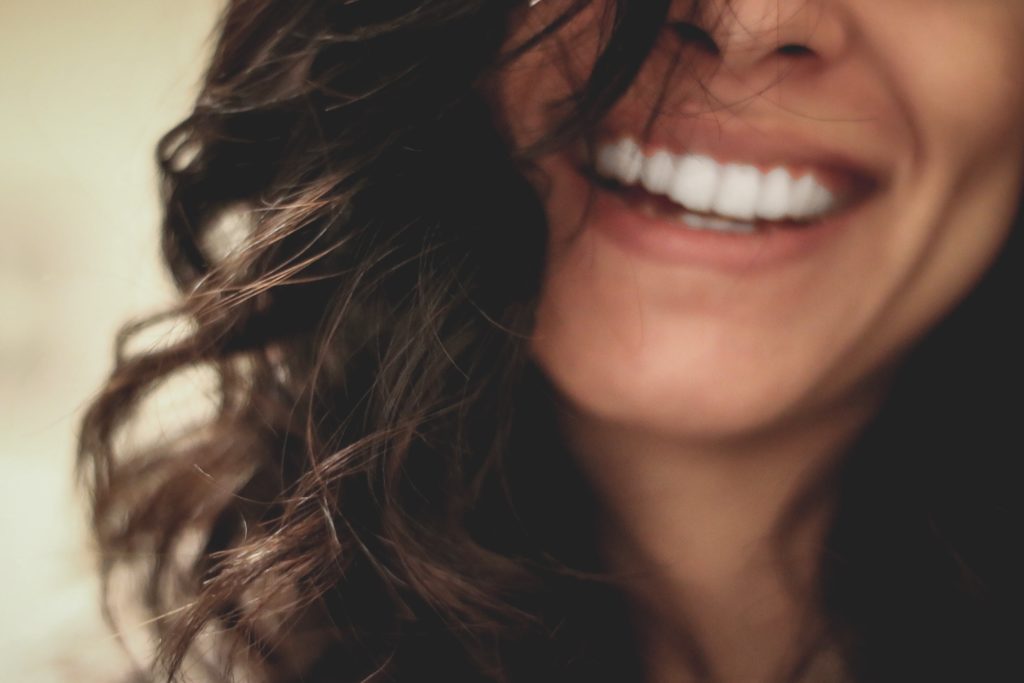 Smiling brunette woman with white teeth.