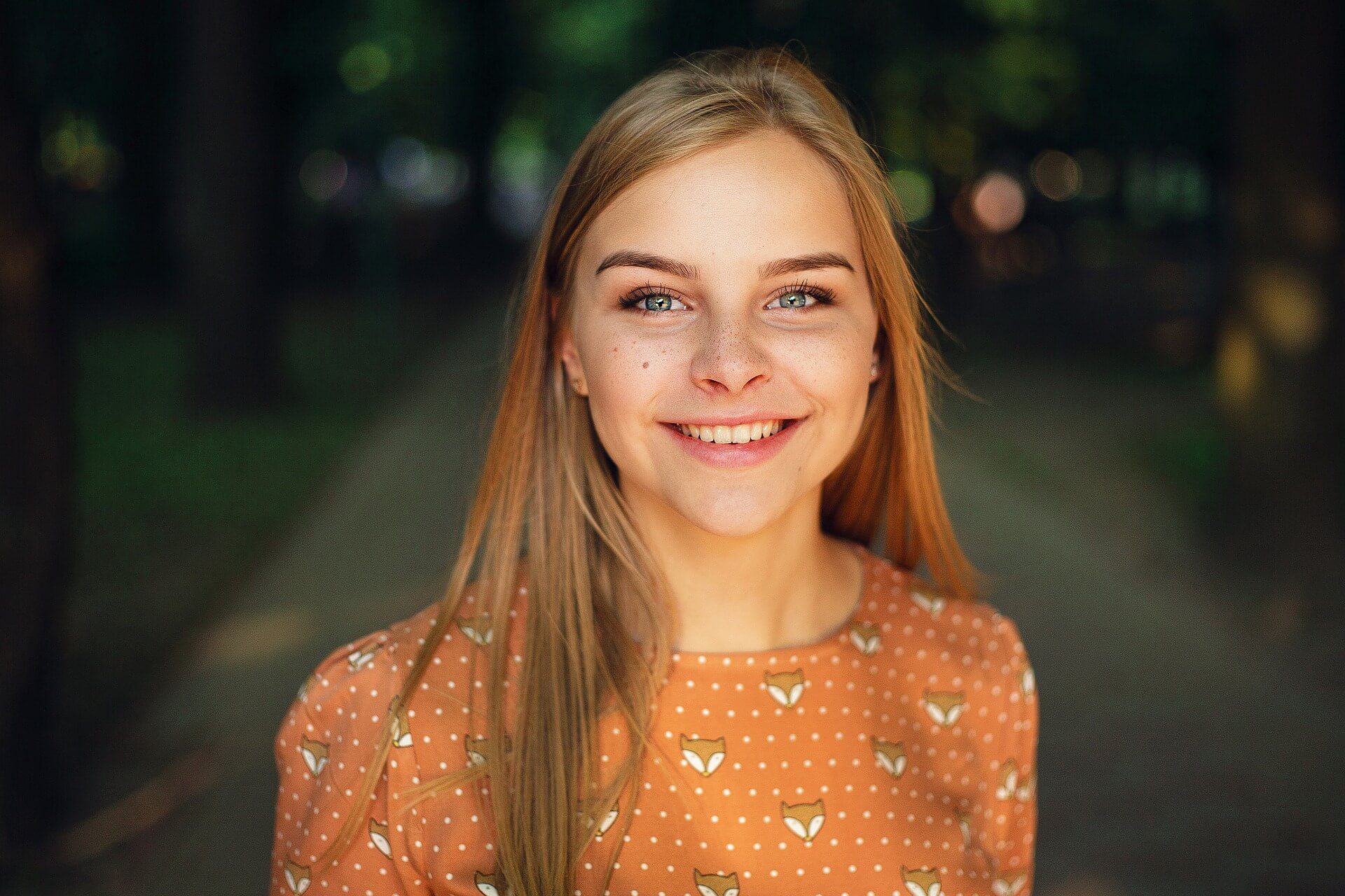 woman smiling after Invisalign treatment