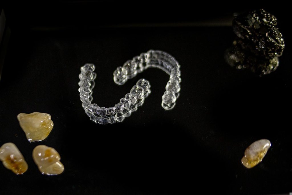 photo of clear aligners on black background