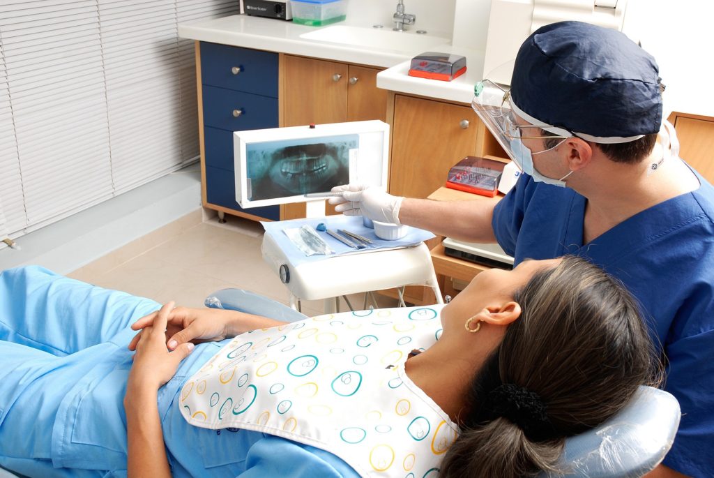 woman lying in a dental chair discussing teeth alignment