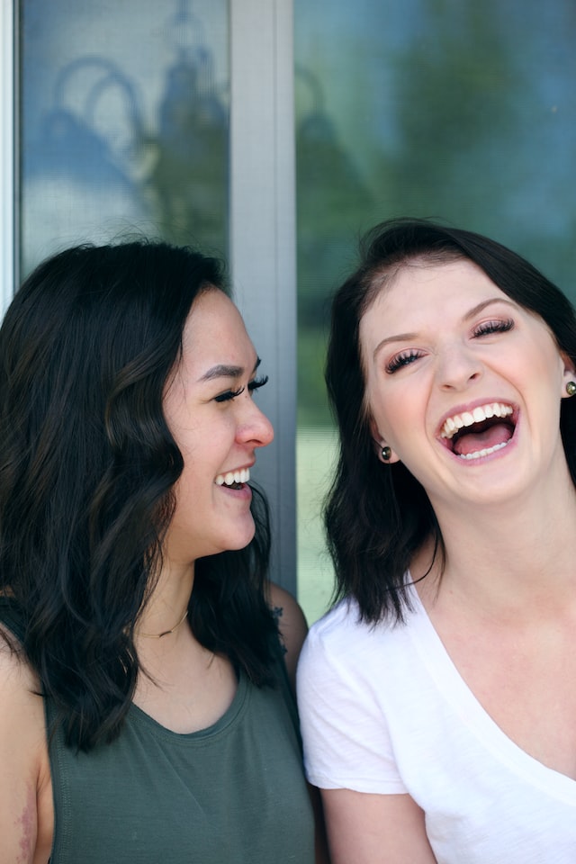 Two friends smiling after visiting the dentist