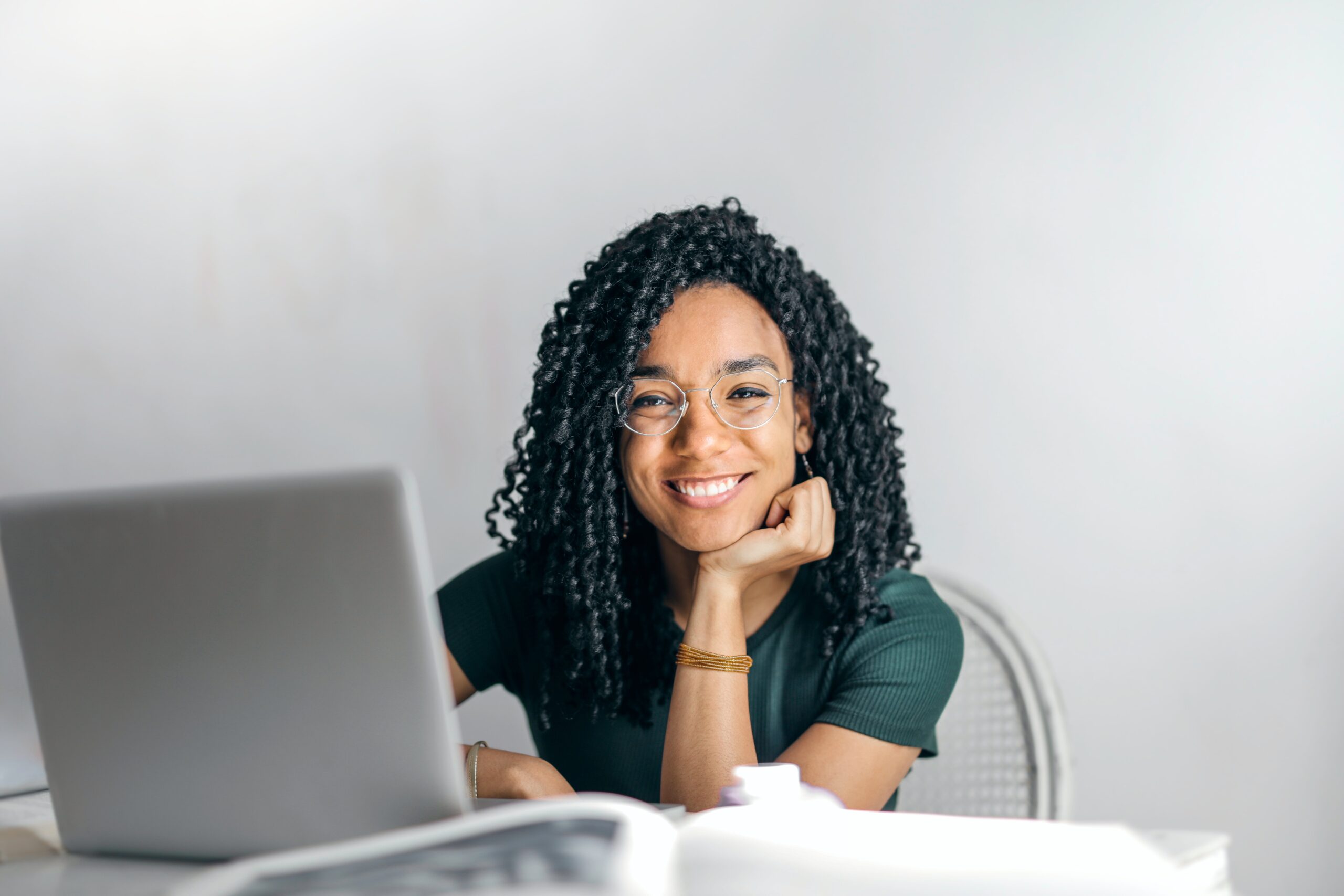 woman smiling in front of a white background