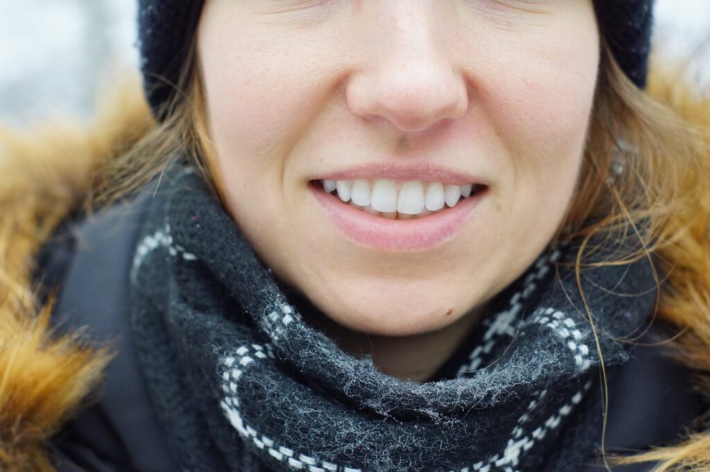 woman smiling with a black scarf