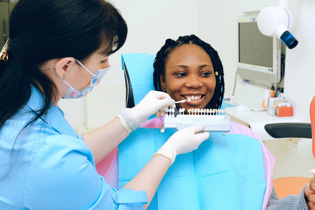 A woman getting color matched for a restorative dentistry procedure.