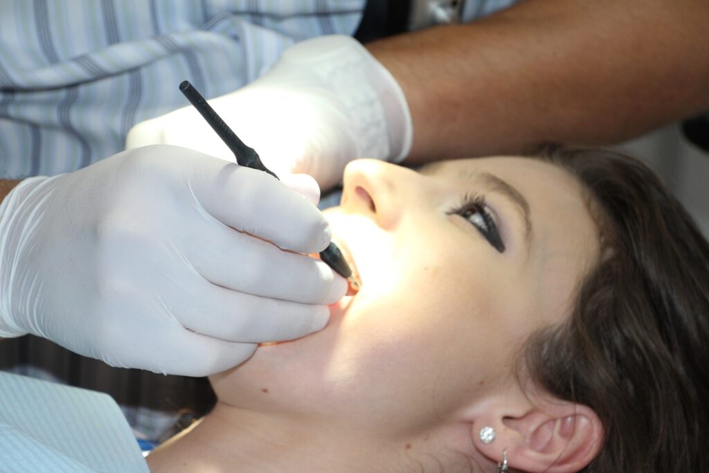 A woman getting her teeth cleaned by a dentist