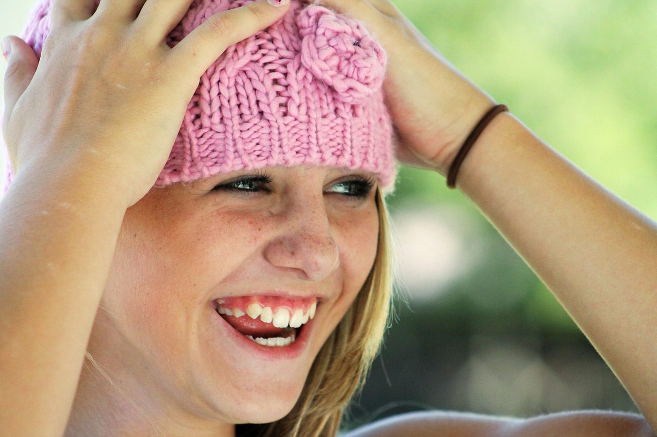 girl smiling with pink bonnet