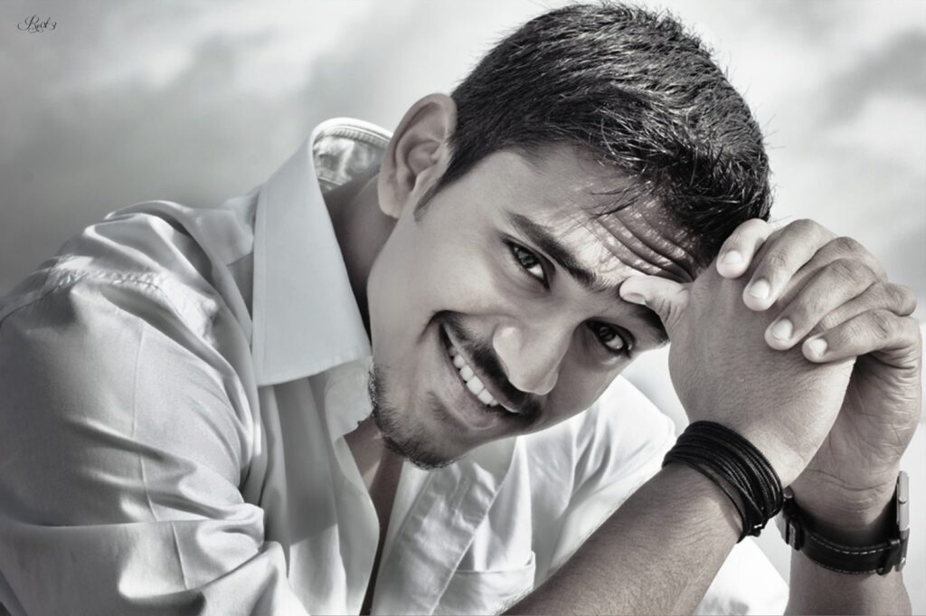 A man smiling in black and white after visiting his new dentist in Norwalk