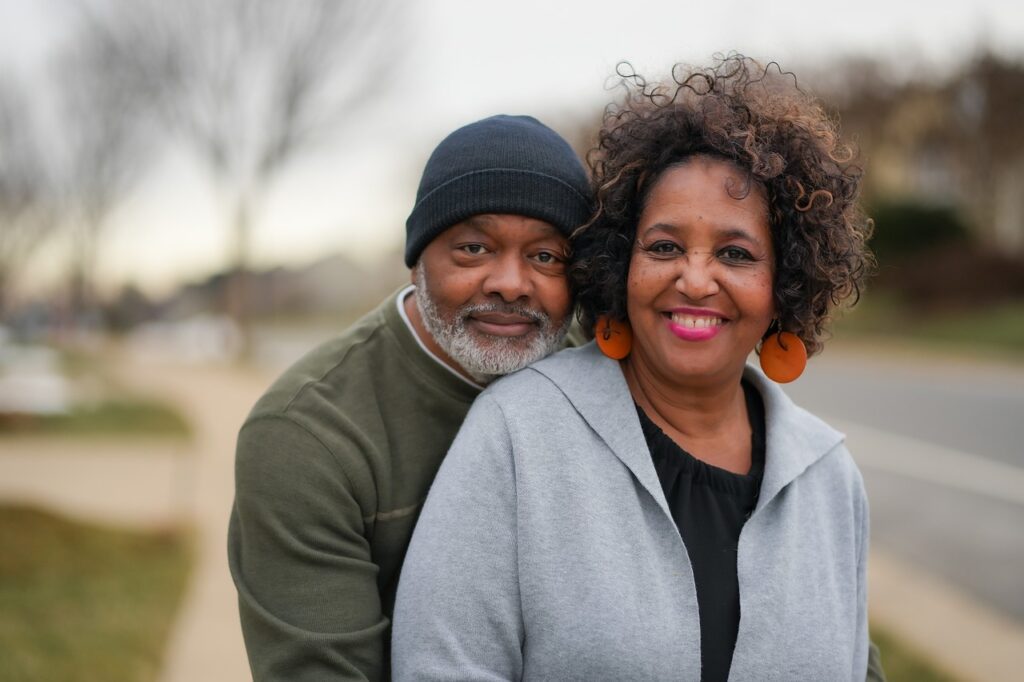 man and woman smiling on a sidewalk